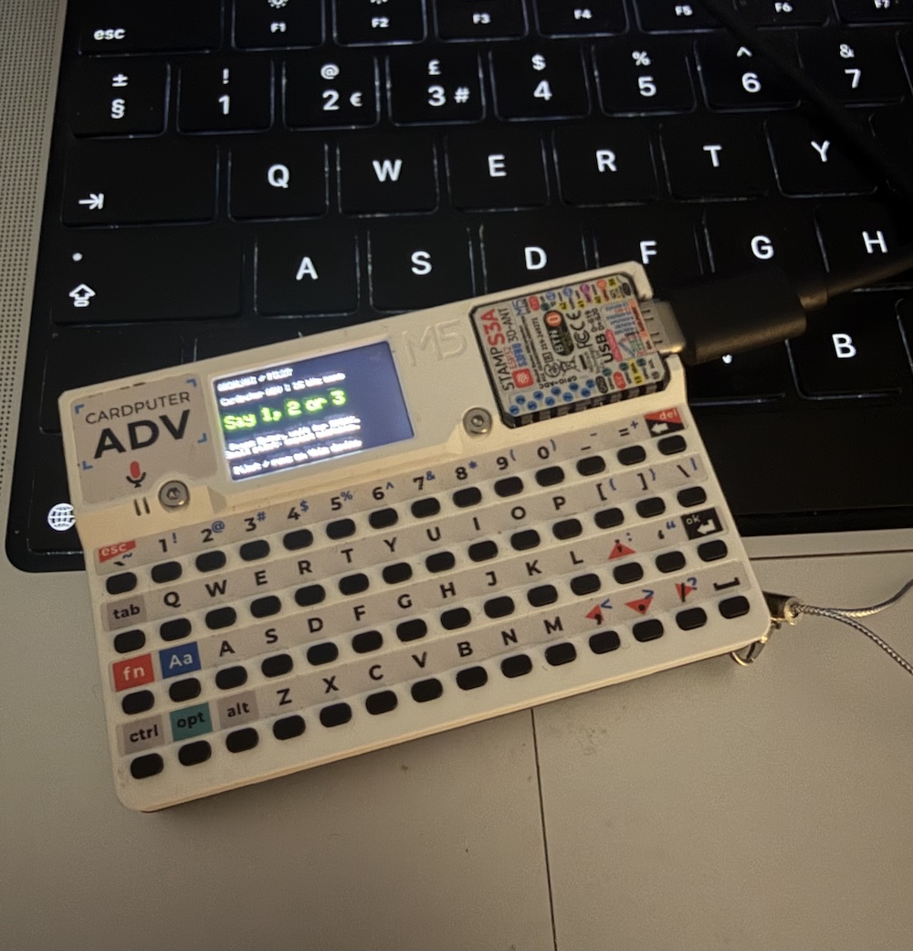 Cardputer resting on a laptop, with the Kurdish number classifier prompting me to say 1, 2, or 3.